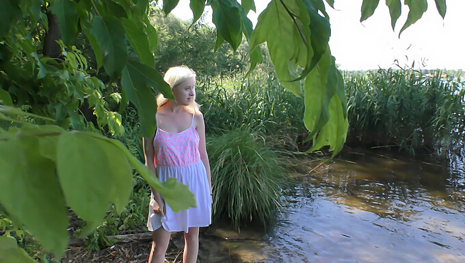 A spontaneous outdoor romp by the lake with a blonde teen