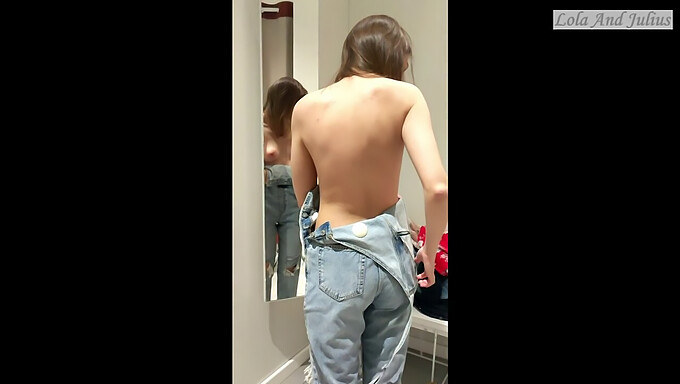 Softcore video of a babe in lingerie using a smartphone in the changing room